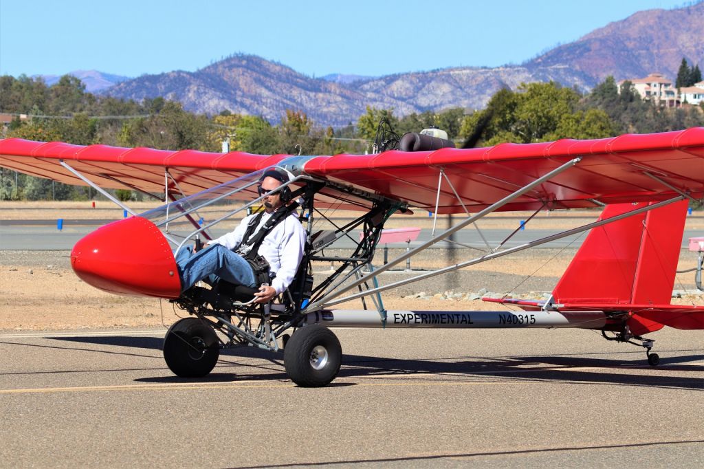 — — - KO85 - Oct 2019 Benton Air Faire Redding, CA shows an Ultra Light headed to the main runway for a Demo flight. This was really cool to see fly and Jim Ostrich runs a great Air Faire at Redding - a must see bucket list show. The hills in the background west are compleletly torched by the devestating CARR Fire 2018 that destroyed over 1100 homes, started by a faulty wheel bearing on a travel trailer throwing sparks into overgrown brush along Hwy 299W in the Whiskeytown NRA.