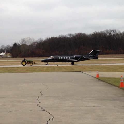 Learjet 31 (N351AC) - At University of Notre Dame....getting pulled out of hangar by John Deere tractor