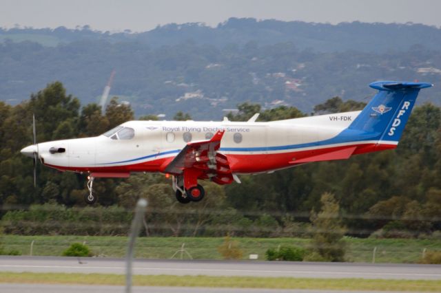 Pilatus PC-12 (VH-FDK) - About to put down on runway 05. Thursday, 19 June 2014.