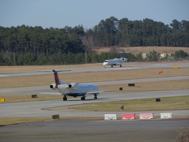 Embraer ERJ-145 — - Two Delta Connection (Shuttle America) Embraer ERJ 145s in one shot taxiing by each other, N571RP taxiing and N286SK lined up for takeoff. Almost like twins! :) Taken January 30, 2016.