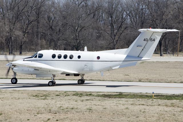 Beechcraft Super King Air 200 (84-0154) - C-12F taxis out for departure, a US Army Brigadier General's ride, as evident by the flag in the last window. -March 2014