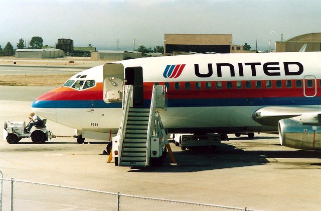 Boeing 737-200 (N988UA) - KMRY - This was how close we used to be able to photograph the jets at KMRY - until they built a huge glass wall on the outdoor observation deck. Pissed me off so bad I rarely went back to KMRY to film.