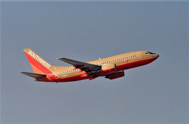 Boeing 737-700 (N731SA) - KSJC - mid 1990s when Runway 30L was being re done and extended, all airline traffic was using Runway 30R, that was was fairly new then and air traffic departing 30R was a lot closer to the camera than 30L. Shown here is N731SA minus winglets and new paint headed for one of the many destinations out of San Jose - filmed from atop the Terminal A parking structure.