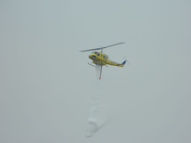 Beechcraft King Air 90 (N2777W) - UH-1H doing a water drop demo. 1/26/2012