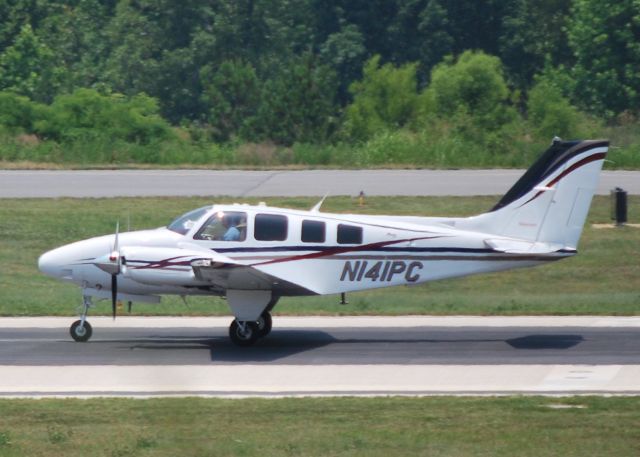 Beechcraft Baron (58) (N141PC) - CLEGGS TERMITE AND PEST CONTROL departing runway 20 at KJQF - 6/8/11