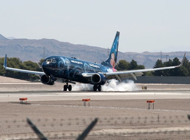 Boeing 737-800 (C-GWSZ) - Westjets Walt Disney World 737-800 touching down on runway 25L.