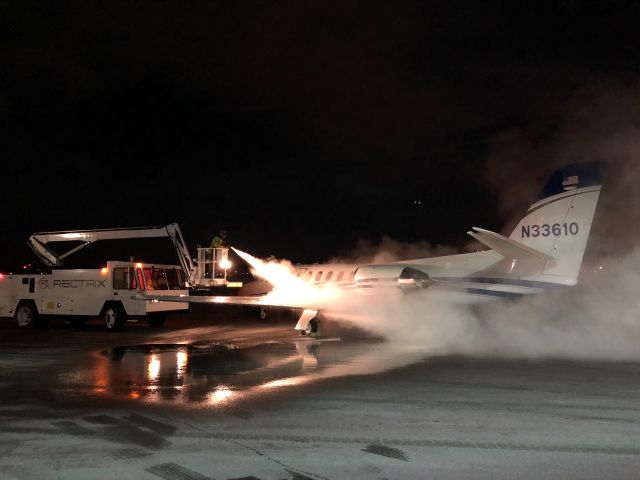 Cessna Citation II (N33610) - Unusual conditions caused ice formation on all exposed surfaces while parked at KBED, requiring a full deice prior to a late evening departure. The lighting created an interesting effect with the fluid spray, making it look as though the airplane was being deiced with a flame thrower.