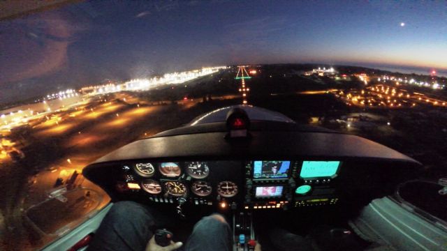 Diamond Star (N243DS) - Landing at Dusk Runway 16R at Paine Field (KPAE) in Everett, Washington. Thats the largest Boeing plant on the left, Puget Sound and the moon on the right.