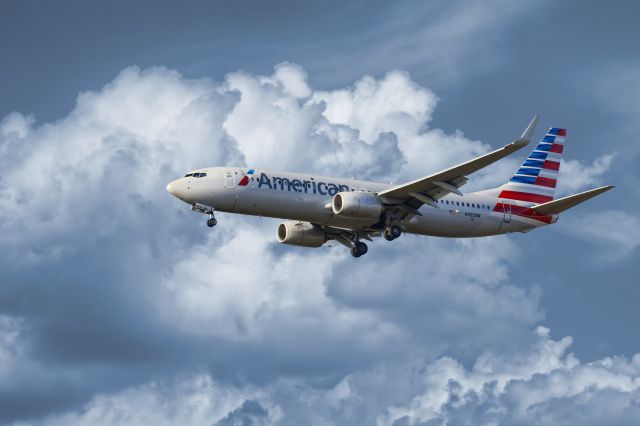 Boeing 737-800 (N985NN) - This is a composite I built together using two photos. One of cloud formation and another of an arrival of an American Airlines Boeing 737 jet. The paint scheme of the aircraft lends itself well to these dramatic colors and thought it was go nicely as an artistic photo!br /br /Hope you enjoy :)