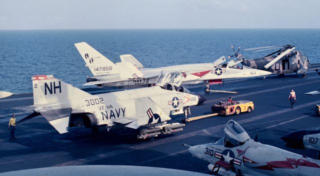 15-3002 — - An F4B of VF-114 loaded with 12 high drag(Snake Eye) Mark 82 bombs and 4 AIM-7 Sparrow air to air missiles is spotted forward on USS Kitty Hawk for a strike package launch into Route Pack 6B from Yankee Station in the South China Sea Jan. 1967.  On 15 Apr 1968 F4B BuNo 153002 operating as Linfield 202 and F4B BuNo 153043 flying as Linfield 214 were lost in a mid-air collision over water while jinking in an attempt to break fire control radar lock on. The crews, LCDR John F. Farnsworth, LTJG Gerald K. Baer, pilots, and LTJG Joseph M. Sarnecky, LTJG Roy L. McCready, RIOs, ejected, and despite heavy 37-50-100mm fire from the beach, were rescued by helo and returned back aboard Kitty Hawk. Picture made from 06 level "Vulture's Row".