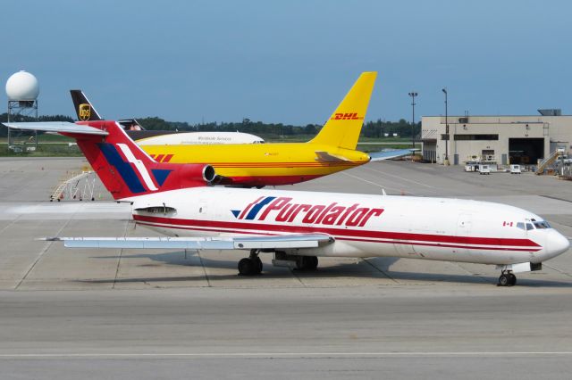 BOEING 727-200 (C-GIKF) - C-GIKF is seen here with N653GT, an Atlas Air 767-200SF, followed by UPS A300F4-600R N170UP and a bit of a Cargojet 727-200F tail. This view can be attained from the lookout at the Canadian Warplane Heritage Museum at Hamilton Airport. C-GIKF was scrapped on December 20, 2014, just months after this picture was taken.