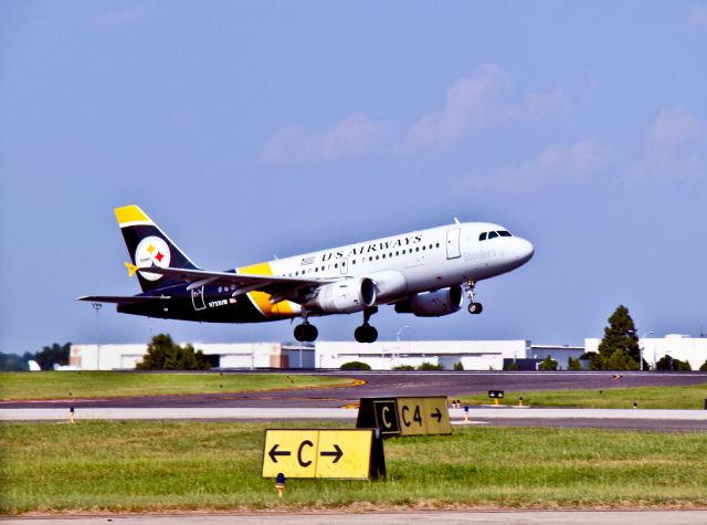 Airbus A319 (N733UW) - Late afternoon take off from Charlotte, North Carolina. This is a regular US Airways passenger aircraft painted in the Pittsburgh, Pennsylvania "Steelers" football team colors.
