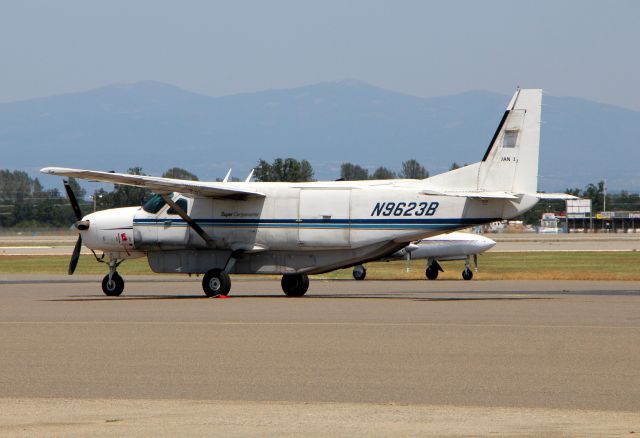 Cessna Caravan (N9623B) - KRDD - Cessna 208 Super cargomaster package express, at Redding parked for the weekend. The area in the right background of the photo is the Redding Dragstrip.