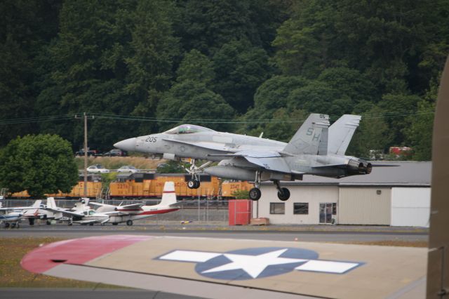 McDonnell Douglas FA-18 Hornet — - F-18 from VMFAT-101 landing at KBFI 6-20-09.  The B-17 wing in the foreground is from the Collings Foundations Nine O Nine.