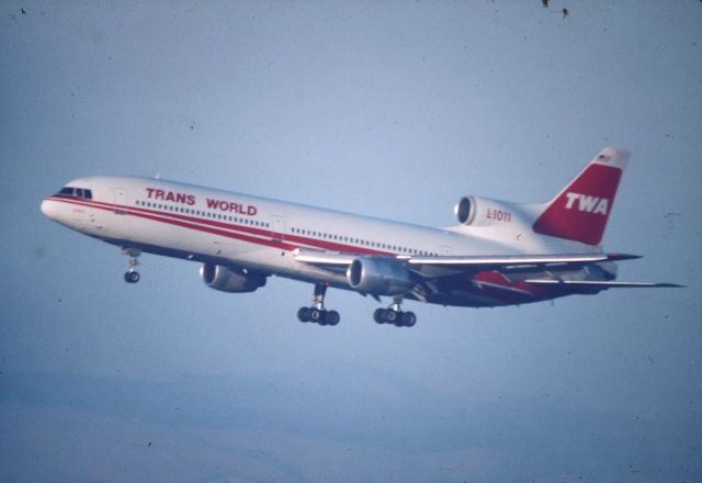 Lockheed L-1011 TriStar (N11003) - KSFO - TWA L-1011 over the numbers for 28L - 1000mm lens hand-held from the dirt lots by SFO before Bayfront Park was built. Slight blur as the C-90 ( Celestron ) was a tough lens to focus on fast moving jets. date apprx mid to late 1990s.