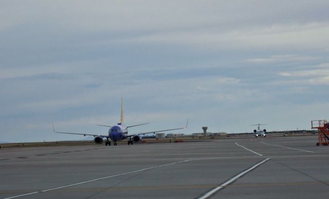 Boeing 737-700 (N215WN) - Mesa Airlines Bombardier CRJ-900ER, N944LR in the background.