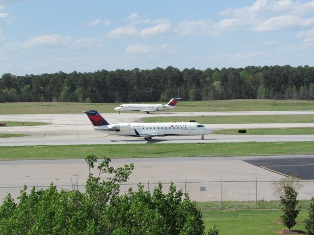 Canadair Regional Jet CRJ-200 — - TWO Delta Connection Bombardier CRJ200s in one shot! N8972E taxiing in the front, N8905F on takeoff in the back. (4/2/16)