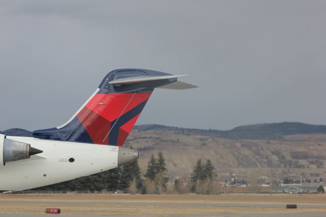 Canadair Regional Jet CRJ-700 (N713EV) - N713EV at Butte after landing from KSLC as SKYWEST 4312. Engines just turned off, with the APU on with the Berkeley Pit behind it.br /br /Taken 17:03, November 2, 2024 with a Canon EOS T2i and 70-300mm (115mm, 1/200, ƒ5, ISO 100)