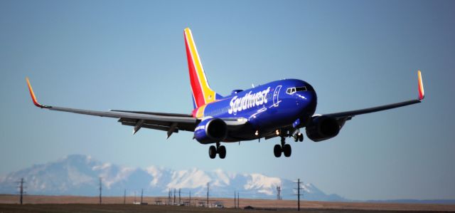 Boeing 737-700 (N743SW) - Landing on 35L. Pikes Peak in the background.