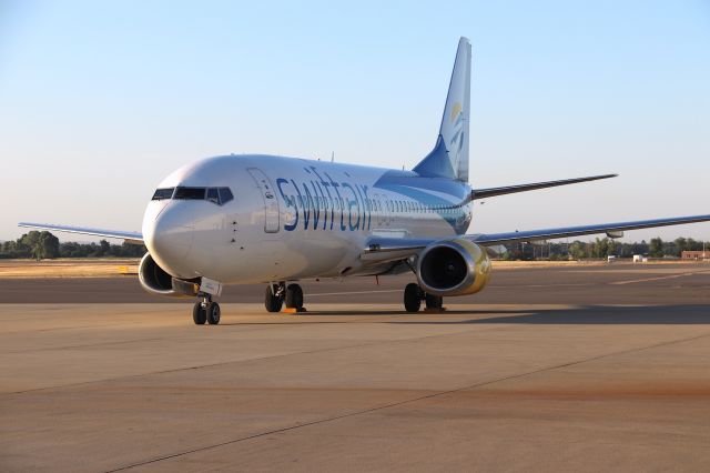 BOEING 737-400 (N285XA) - KRDD - Charter Swift Air at Redding 7/17/2019 basking in the warm weather. 737-400s rare at Redding...NOTE: under the cabin door, is the slot for the built in airstairs.