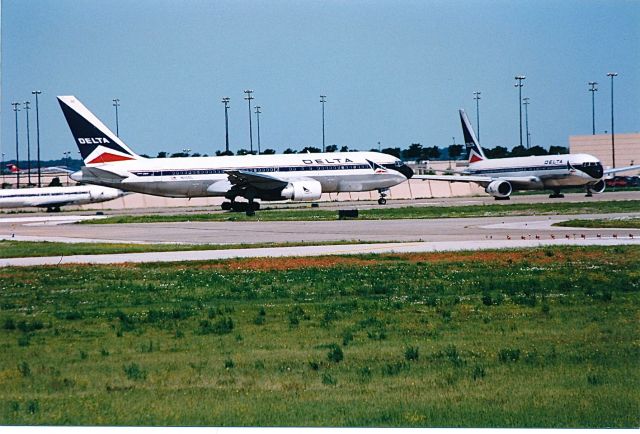 BOEING 767-200 (N110DL) - Delta Airlines B-767-200 starting its takeoff roll with a Delta B-766-300 watching in the back ground