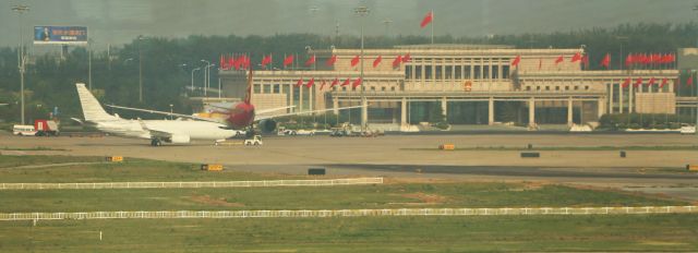 Boeing 737-700 (N2708E) - 6/23/18 B737-7LT being towed across the government ramp at Beijing, with Hainan parked behind it.