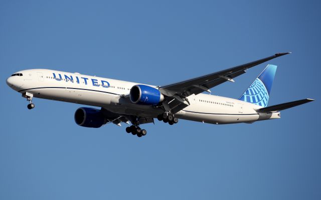 BOEING 777-300ER (N2352U) - Short Final to Rwy 16R."Connecting People Uniting The World" written under flight deck.