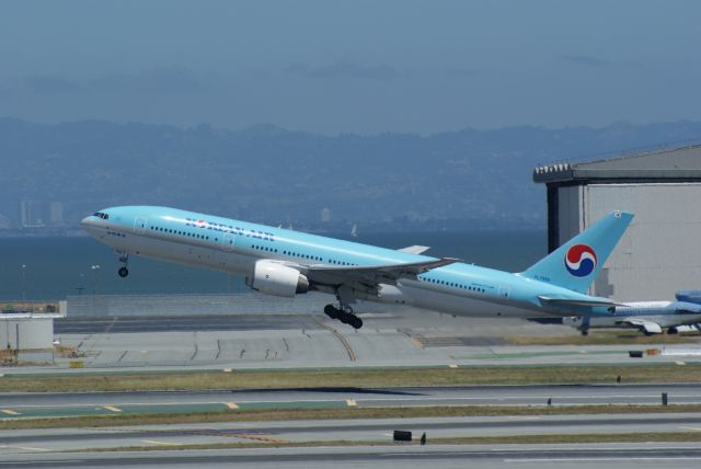 Boeing 777-200 (HL7598) - Koran Air taking off in a sunny day at San Francisco Airport.