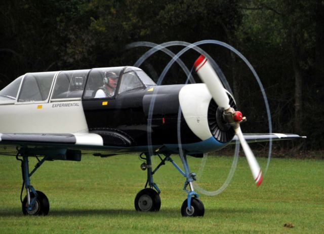 — — - Yak-52 departing with full throttle and perfect condition to create the rarely seen, multiple moisture trails departing the trailing edge of the prop.  Photo Copyright: BlakeMathis.com