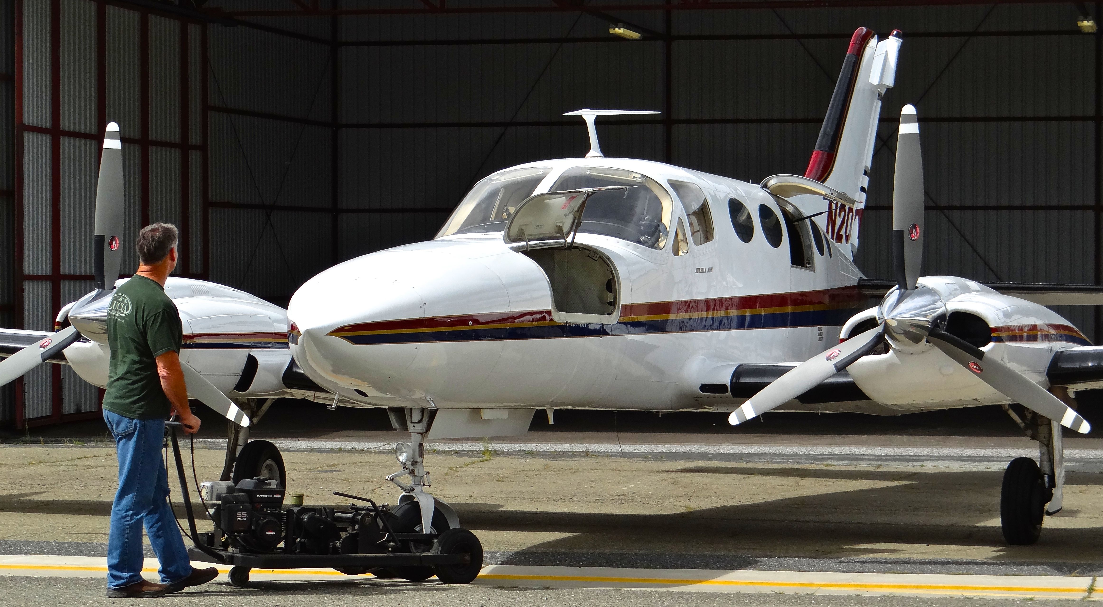 Cessna 421 (N200WM) - Pushing back a local Cessna 421 into its hangar.