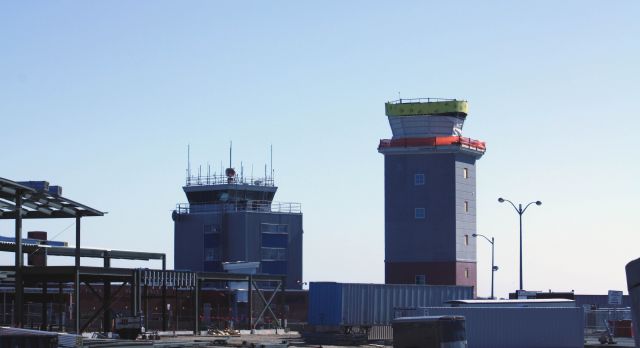 — — - The current tower on the left while the new tower being built on the right at HYA as of Feb. 2011.