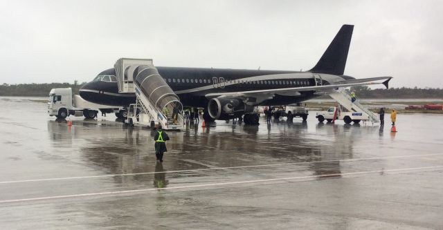 Airbus A320 (LY-COM) - Rain, picking up Canadian tourist at SCU for YYZ Toronto