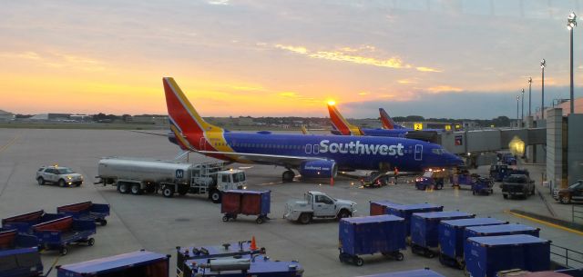 Boeing 737-800 (N8686A) - Rising sun kisses the tail of Southwest planes getting ready for passengers at Terminal A, Bradley Airfield.