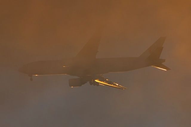 Boeing 777-200 — - Landing through the Sunset Clouds