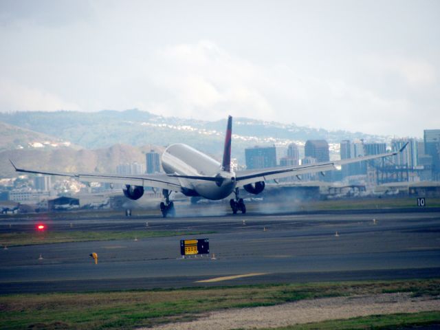 Airbus A330-200 — - was waiting to depart for Maui the pilot told us 3 aircraft was on final and we had to wait for takeoff so i took the chance to get some great shots of them and this was the best