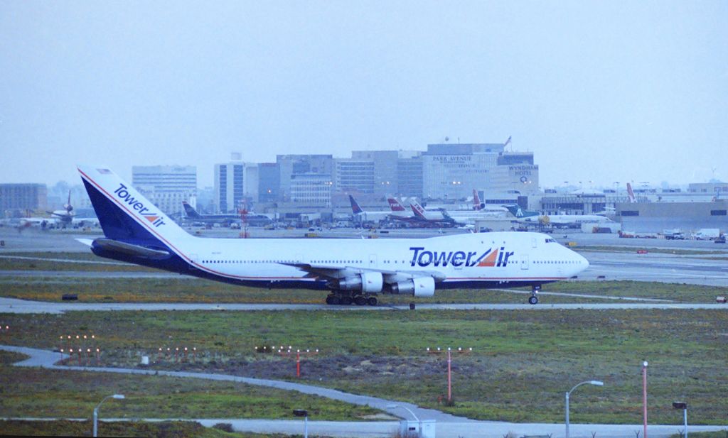 Boeing 747-200 — - KLAX - I did a crappy job scanning this negative, cant read the reg,,but will take me 6 mos to find the negative again, This was taken from "Hooker Hill" on the west end of LAX 24LR, the Pacific Ocean behind me, and 24LR arrivals as i was hoping for great 24R Intl 'Heavy' arrivals smoking the mains and rolling out like Tower Air 747 did here all the way to the end. I was using video most of the day here as L1011s and DC-10s - 767s and 747s landed and departed most of the day, I got tired of standing on the ladder all afternoon in the back of the pickup truck, We left and went to dinner at Woody's Steakhouse on Sepulveda Blvd near the Hacienda Hotel was where the LAX Airline Collectible show was this weekend.....I think this was 1995-98. I'll find the reg one of these days...I sure hope Ididnt already post this photo before....without the reg, I'll never know