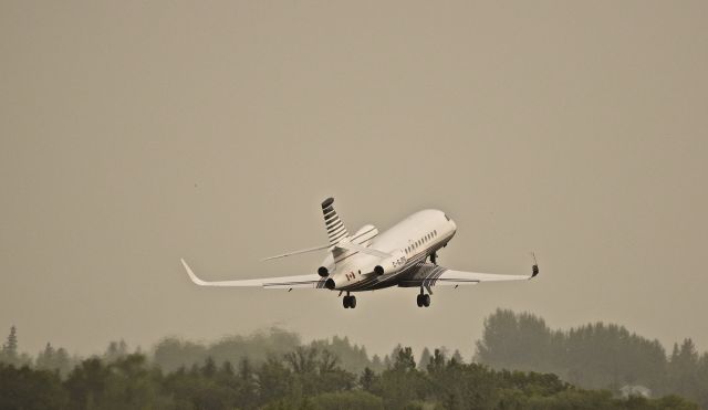 Dassault Falcon 900 (C-GJPG) - This Falcon gets airborne on a rainy, cloudy day on its way to Edmonton