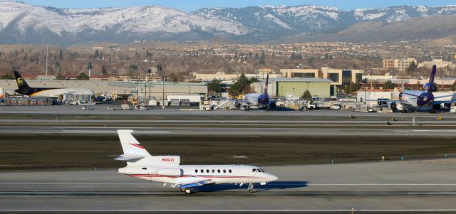 Dassault Falcon 50 (N96UT) - Backtaxiing down runway 16L at Reno Tahoe International, Democratic presidential candidate Hillary Clintons chartered Dassault Falcon 50 passes a pair of B757s and a DC-10 as it is about to make an early morning departure following Ms. Clintons overnight stay in Reno.