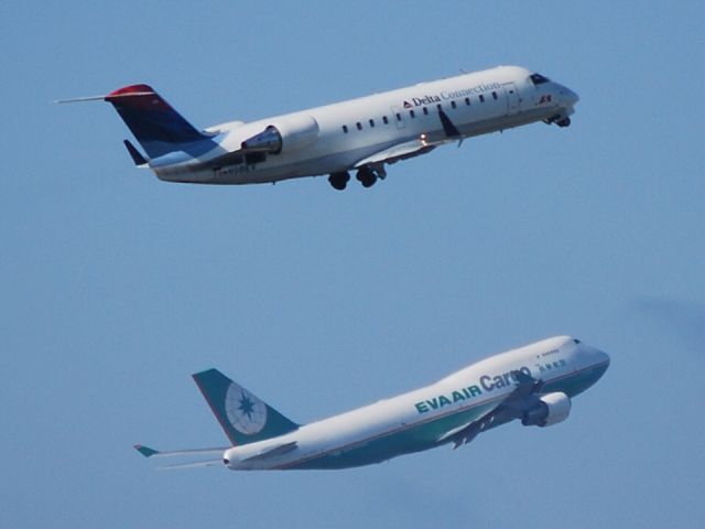 KATL — - Delta CRJ2 departing from 26R, while an EVA AIR Cargo 744 departs from 27R - 8/23/09