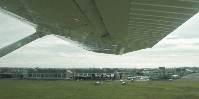 Cessna Skyhawk (ZK-KVB) - 12 July 2008, Wigram Airfield, and all our local light aircraft parked outside the huge ex Air Force hangars. The photo was taken by my daughter, as we were flying in the circuit, on the kid's first flight with me. 7 Months later, it was all gone and closed forever. The hangars and art deco style control tower remain as heritage listed buildings, but the airfield has now sadly all been carved up into small lots and covered in houses.