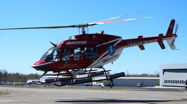 Bell 407 (N914UF) - A backlit Bell 407 GXP, operated by Baldwin County Emergency Medical Services and Medstar, departing H. L. Sonny Callahan Airport, Fairhope, AL - late morning, March 4, 2021. 