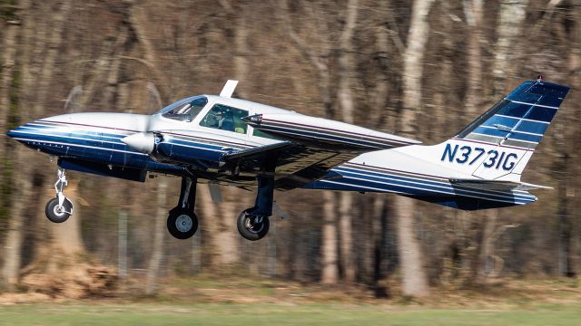 Cessna 310 (N3731G) - N3731G climbing out of College Park Airport's runway 33 for a flight to University Park