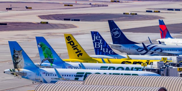 Airbus A320 (N763JB) - A diverse range of tails, including JetBlue What's Old is Blue Again retro livery A320 and Delta SkyTeam 737-800 parked Terminal 3 of PHX on 11/19/22. Taken with a Canon 850D and Tamron 150-600 G2 lens.