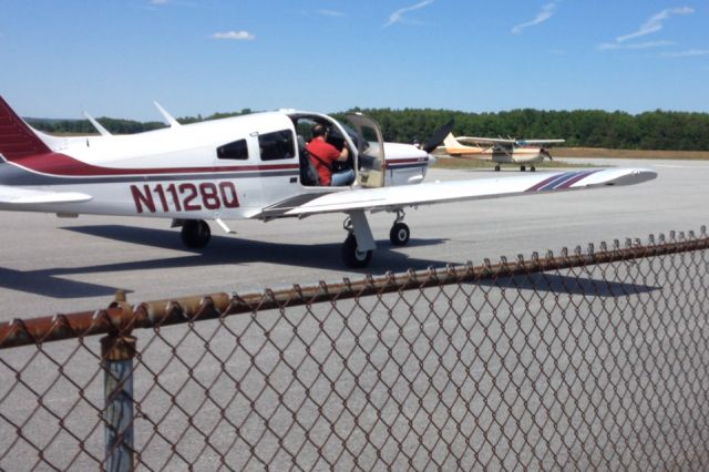 Piper Cherokee (N1128Q) - 1977 Piper PA-28R-201 at Saratoga County Airport starting up the engine before departure. 