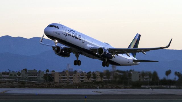 Airbus A320 (N329JB) - Morning departure from LAX. The caption on the nose claims a Giant Leap for Mint Kind. 