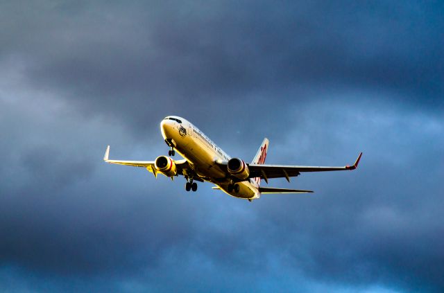 Boeing 737-700 (VH-VUR) - Virgin Australia "Star City" on final approach to RWY-16 at YMEL on a cloudy overcast afternoon - the dramatic dark clouds creates a fitting background with the setting sun on the side of the aircraft
