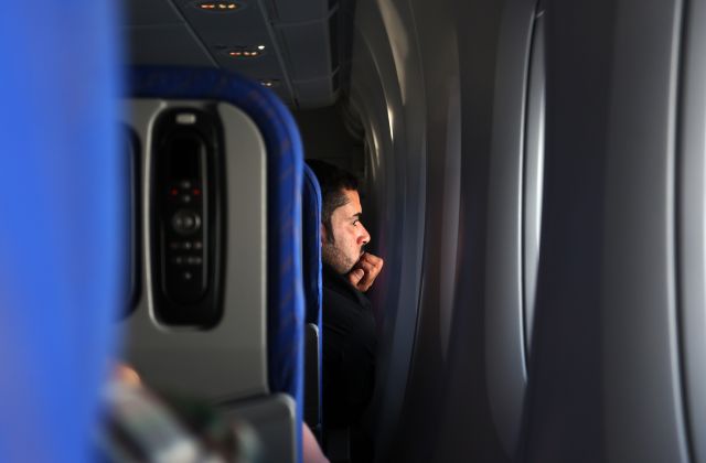 Airbus A380-800 (B-6140) - A man looking outside of window.