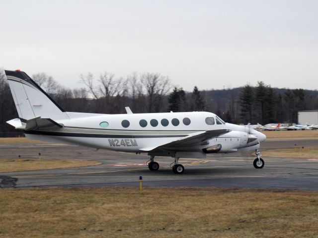 Beechcraft King Air 100 (N24EM) - Taxiing out for a departure on runway 26 at Danbury CT. CFM (Corporate Flight Management) has 3 x King Air 100, 2 x Phenom 100 and 2 x Citation V available for charter in the New York metropolitan area KDXR KHPN KTEB KBDR  a rel=nofollow href=www.FLYCFM.COMwww.FLYCFM.COM/a