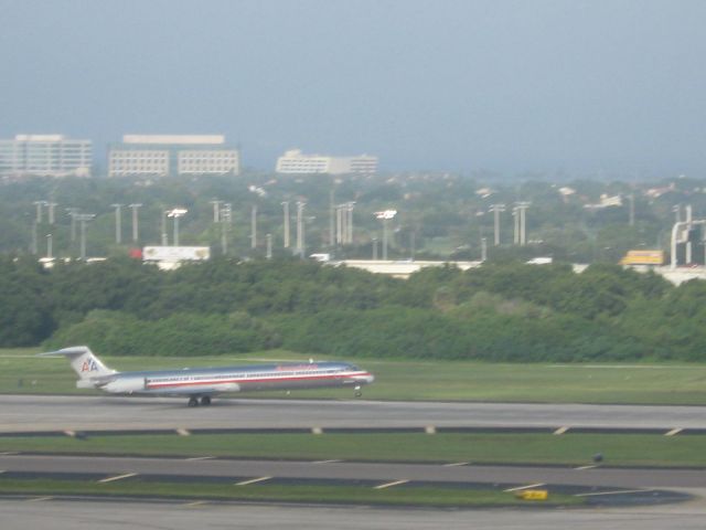 McDonnell Douglas MD-90 — - American MD-90 rotating on rwy. 1L at Tampa, with Tampa Stadium in the background.