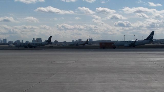 — — - Heavy winds, Runways 33R and 33L in use. Notice the Republic Airways E190, it come here on charter from ACY-rare sight.